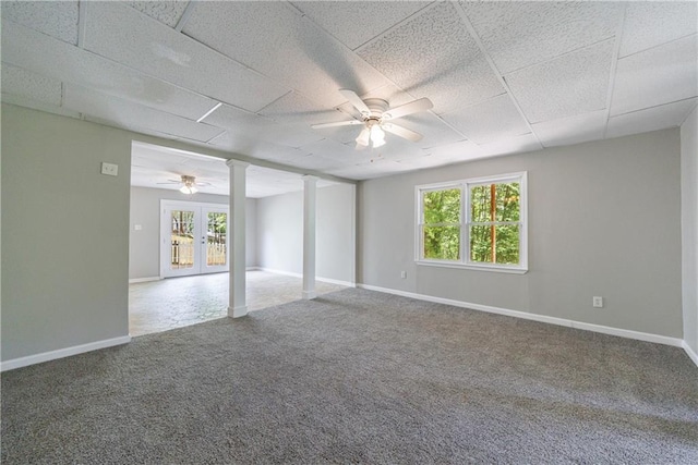 spare room with decorative columns, a paneled ceiling, a ceiling fan, and carpet floors