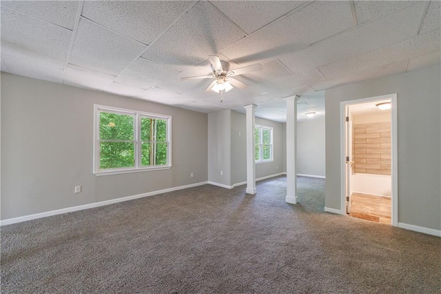 spare room featuring a ceiling fan, carpet flooring, baseboards, and decorative columns