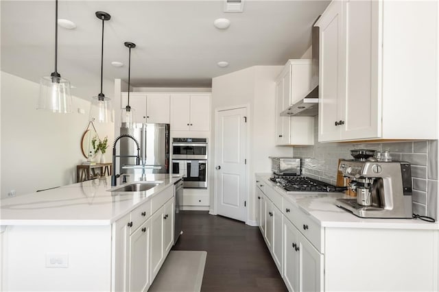 5025 Bryce Ln, Cumming, GA 30040 - kitchen with a sink, stainless steel appliances, white cabinets, tasteful backsplash, and decorative light fixtures