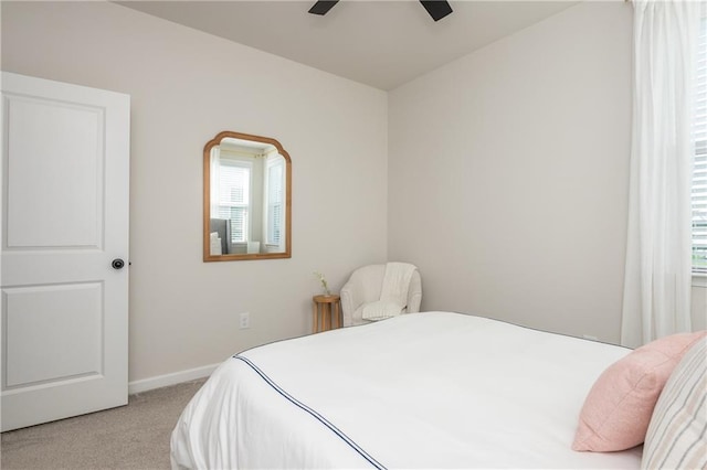 5025 Bryce Ln, Cumming, GA 30040 - bedroom with light colored carpet, multiple windows, baseboards, and ceiling fan