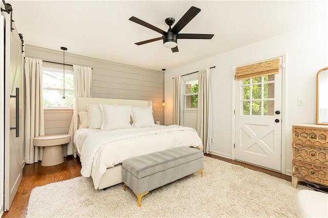 1329 W Nancy Creek Dr NE, Brookhaven, GA 30319 - bedroom featuring wood finished floors, ceiling fan, and a barn door