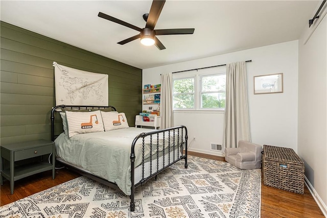 1329 W Nancy Creek Dr NE, Brookhaven, GA 30319 - bedroom with wood finished floors, wooden walls, a ceiling fan, and baseboards