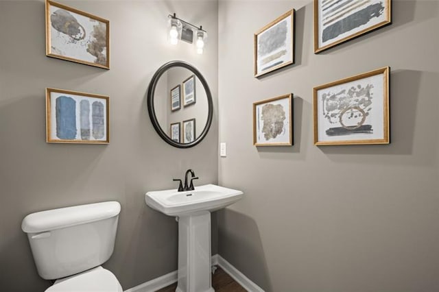 2450 Ravencliff Dr Unit 146, Austell, GA 30168 - bathroom featuring toilet, baseboards, and wood finished floors