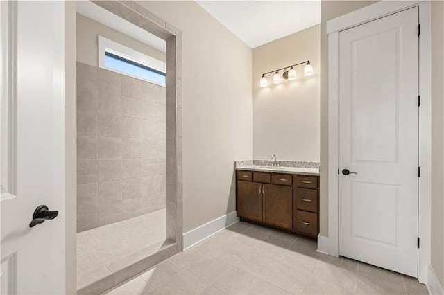 bathroom with walk in shower, tile patterned floors, and vanity