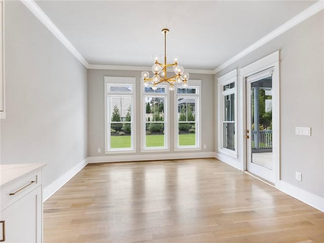 unfurnished dining area featuring crown molding, a healthy amount of sunlight, and light hardwood / wood-style floors