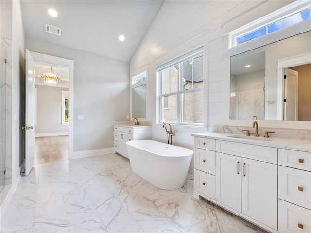 bathroom featuring vanity, vaulted ceiling, and shower with separate bathtub