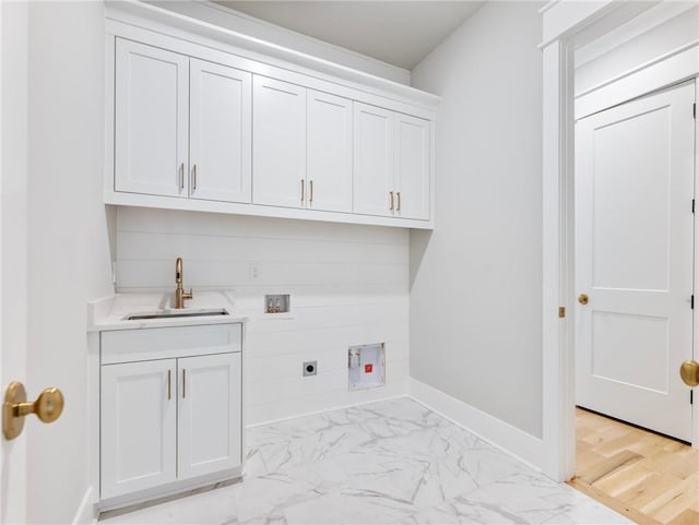 clothes washing area featuring cabinets, hookup for an electric dryer, hookup for a washing machine, and sink