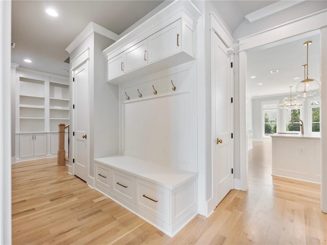 mudroom featuring light hardwood / wood-style flooring and a notable chandelier