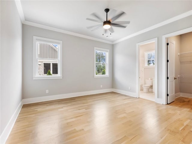 empty room featuring ceiling fan, ornamental molding, and light hardwood / wood-style floors