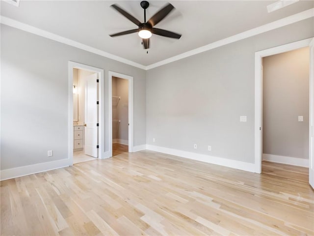 spare room with crown molding, ceiling fan, and light wood-type flooring