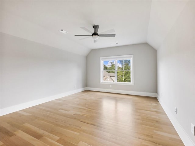 additional living space featuring ceiling fan, lofted ceiling, and light wood-type flooring