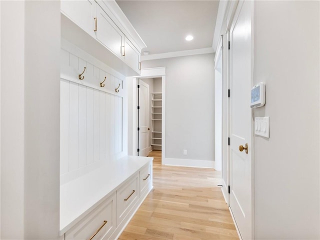 mudroom featuring crown molding and light hardwood / wood-style flooring