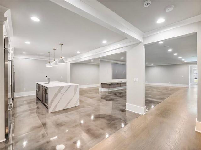 bar with ornamental molding, light stone countertops, sink, and decorative light fixtures