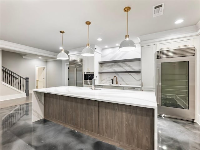 kitchen with stainless steel appliances, sink, pendant lighting, and white cabinets