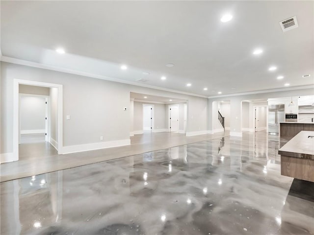 unfurnished living room featuring ornamental molding and concrete flooring