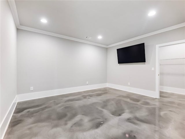 spare room featuring crown molding and concrete floors