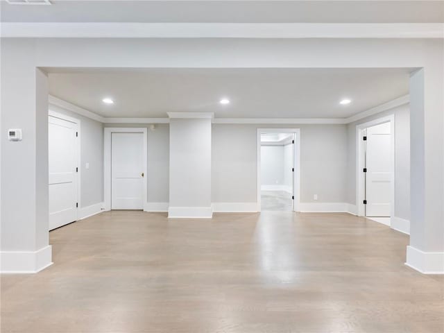 interior space featuring ornamental molding and light wood-type flooring