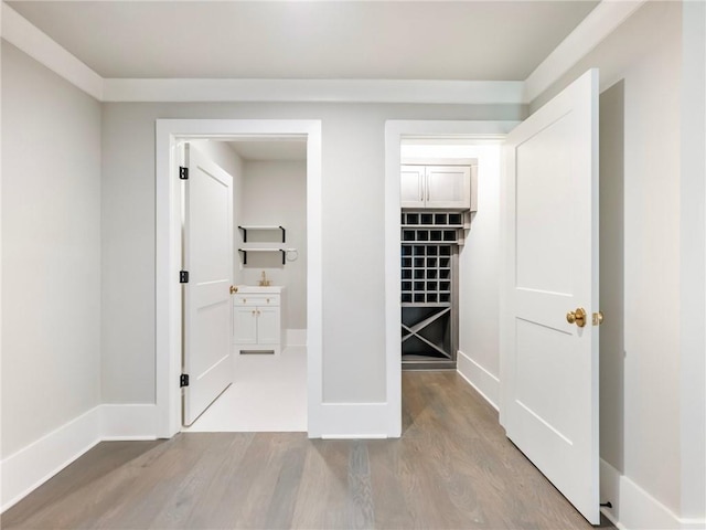 hallway with hardwood / wood-style flooring