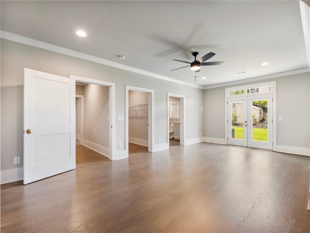 empty room featuring crown molding, dark wood-type flooring, ceiling fan, and french doors