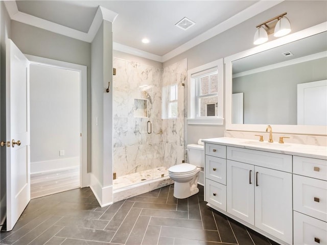 bathroom featuring vanity, a shower with shower door, ornamental molding, and toilet