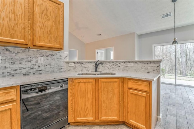 kitchen with sink, dishwasher, light stone counters, and tasteful backsplash