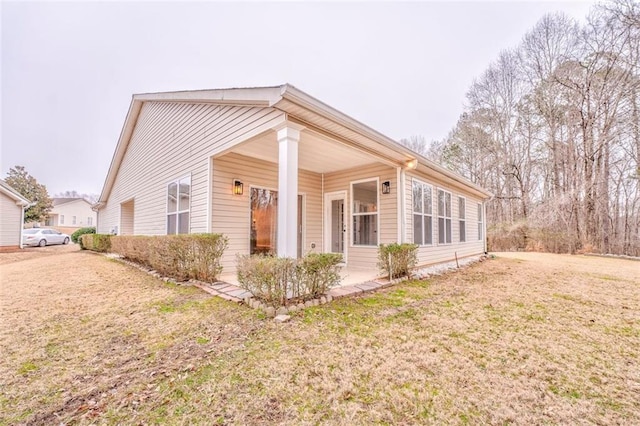 view of side of home featuring a yard