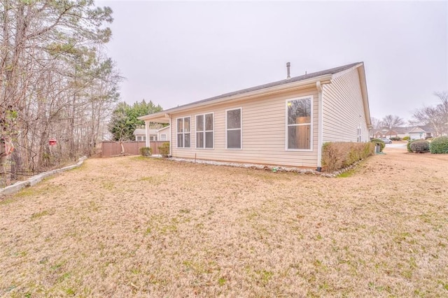 rear view of house with a lawn