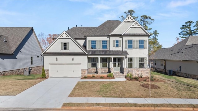 craftsman-style house with a garage, central AC unit, and a front yard