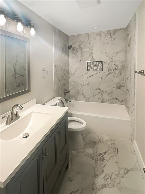 full bathroom featuring toilet, vanity, and tiled shower / bath combo