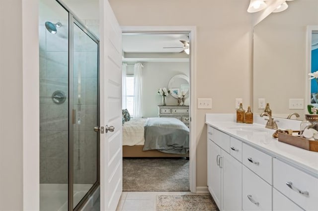 bathroom featuring walk in shower, ceiling fan, vanity, and tile patterned flooring