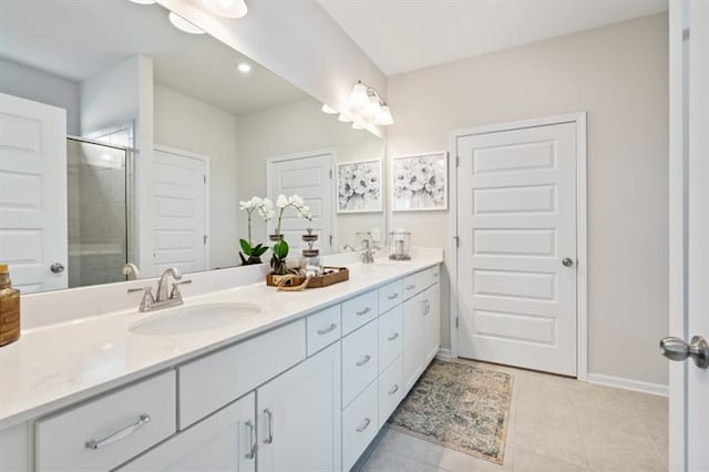 bathroom with vanity, an enclosed shower, and tile patterned flooring