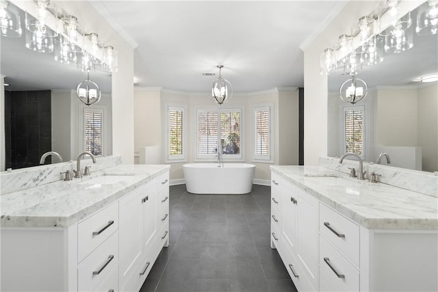 bathroom featuring crown molding, vanity, and a bathtub