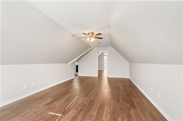 additional living space with dark wood-type flooring, vaulted ceiling, and ceiling fan