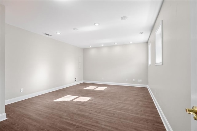 empty room featuring dark hardwood / wood-style flooring