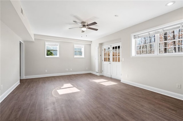 empty room with ceiling fan and dark hardwood / wood-style flooring