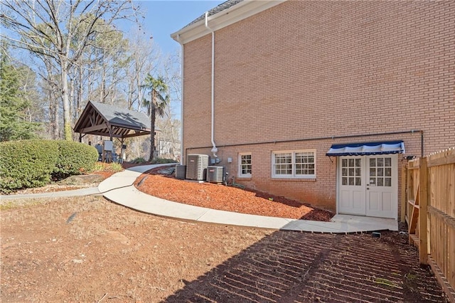 view of side of home featuring a gazebo and central air condition unit