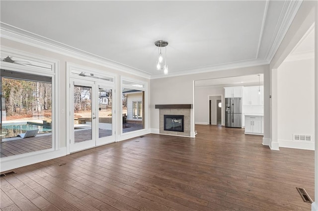 unfurnished living room with crown molding, ceiling fan, and dark hardwood / wood-style floors