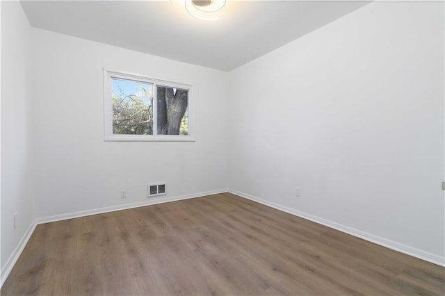 1894 Evans Dr SW, Atlanta, GA 30310 - spare room with wood finished floors, visible vents, and baseboards