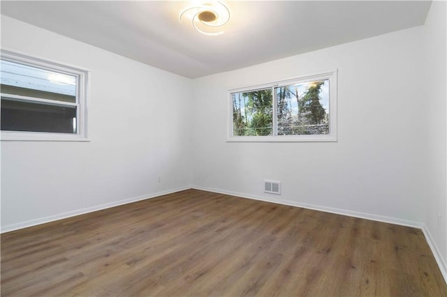 1894 Evans Dr SW, Atlanta, GA 30310 - unfurnished room with wood finished floors, visible vents, and baseboards