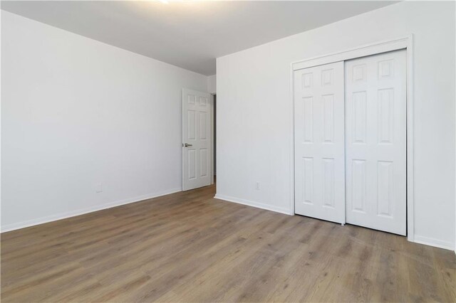 1894 Evans Dr SW, Atlanta, GA 30310 - unfurnished bedroom featuring a closet, baseboards, and wood finished floors