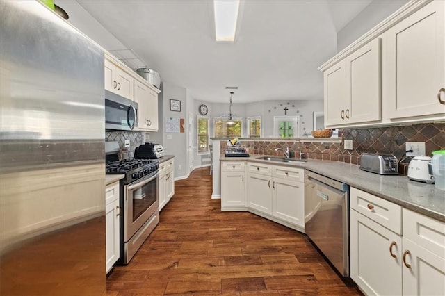 858 Red Rock Ct, Suwanee, GA 30024 - kitchen with appliances with stainless steel finishes, tasteful backsplash, white cabinets, and a peninsula