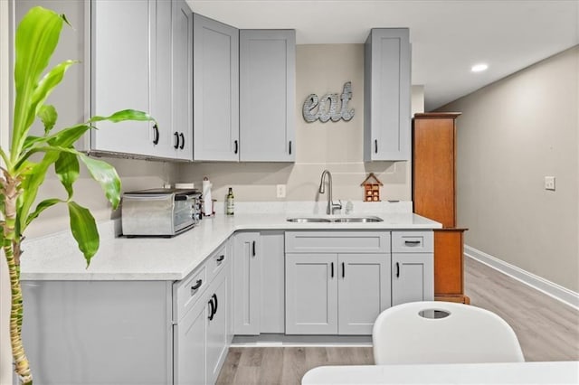 858 Red Rock Ct, Suwanee, GA 30024 - kitchen featuring light wood-style floors, gray cabinets, and recessed lighting