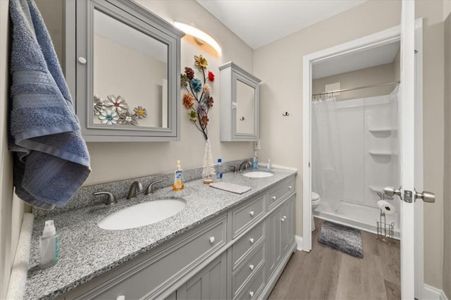 858 Red Rock Ct, Suwanee, GA 30024 - full bathroom featuring wood finished floors, double vanity, and a shower with curtain