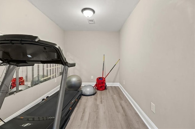 858 Red Rock Ct, Suwanee, GA 30024 - workout area featuring wood finished floors and baseboards