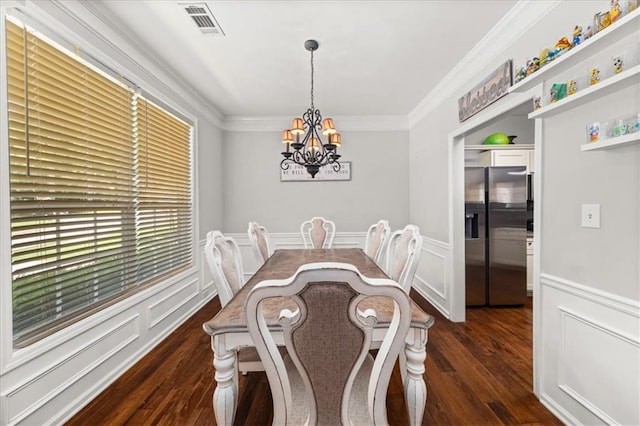 858 Red Rock Ct, Suwanee, GA 30024 - dining space with dark wood-style flooring, a chandelier, ornamental molding, and a wainscoted wall