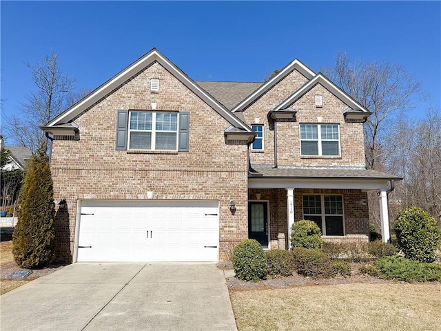 view of front facade with a garage, brick siding, and driveway