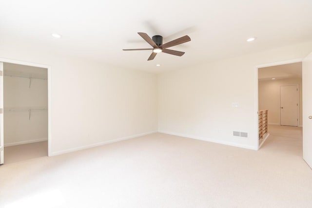 spare room with light carpet and ceiling fan