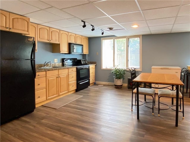 kitchen with track lighting, dark wood-type flooring, black appliances, and light brown cabinetry