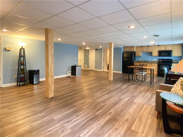 interior space featuring a paneled ceiling and wood-type flooring