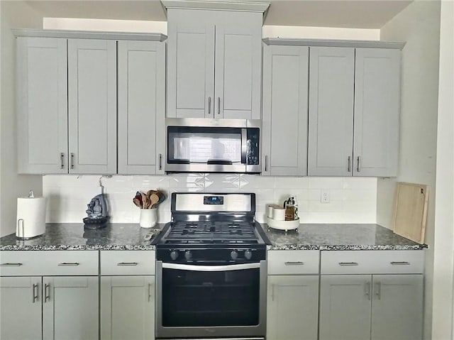 283 Wells Cir, Canton, GA 30114 - kitchen with appliances with stainless steel finishes, dark stone countertops, and backsplash
